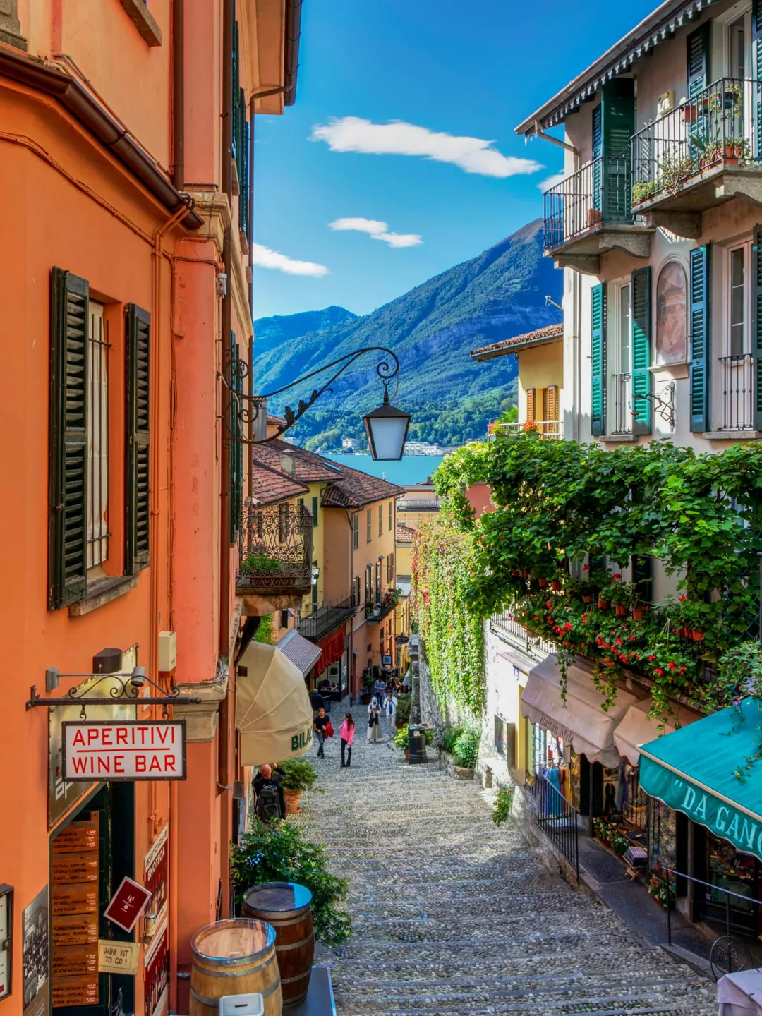 Cobbled street in Bellagio, Lake Como, with terracotta houses and mountains