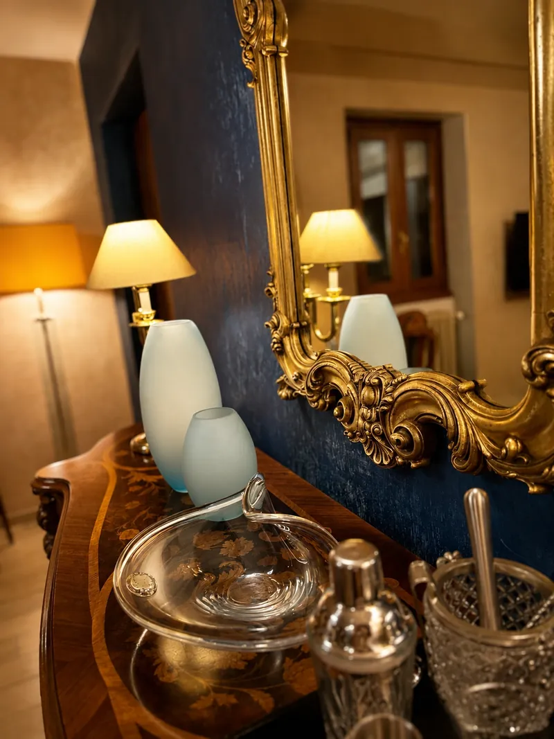 Close detail of glass, silver and a gilded mirror frame