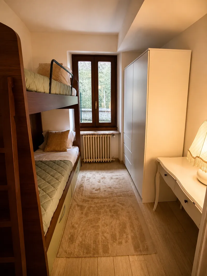 Second bedroom with wooden bunk beds, a window and a white desk
